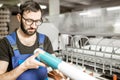 Man with paper tube at the manufacturing Royalty Free Stock Photo