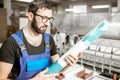 Man with paper tube at the manufacturing Royalty Free Stock Photo
