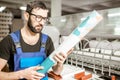 Man with paper tube at the manufacturing Royalty Free Stock Photo