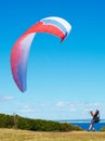 Man, parachute and paragliding launch in nature with safety training, healthy adventure and extreme sport. Person Royalty Free Stock Photo