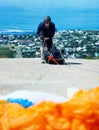 Man, parachute and paragliding sport in launch on hill, healthy adventure and extreme fitness by ocean. Person Royalty Free Stock Photo