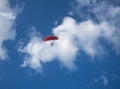 an airplane with a man parasailing through the sky Royalty Free Stock Photo