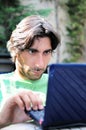 Man at a park cafe on his Laptop Royalty Free Stock Photo