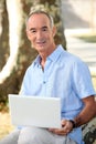 Man in park with laptop Royalty Free Stock Photo