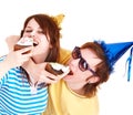 Man in party hat and girl eating cake. Royalty Free Stock Photo