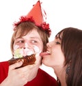 Man in party hat and girl eating cake. Royalty Free Stock Photo