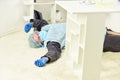 Man passed out. Shortness of breath. Man in protective equipment lay on floor. Severe condition of patient. Self Royalty Free Stock Photo