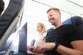 Man passenger flying in airplane and typing on laptop keyboard