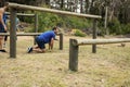 Man passing through hurdles during obstacle course