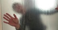 A man pastes a frosted coating on a glass door in a clinic to make the glass door