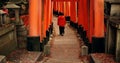 Man on path walking in Torii gate in Kyoto with peace, mindfulness and travel with spiritual history. Architecture Royalty Free Stock Photo