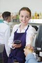 Man paying bill at cafe using card Royalty Free Stock Photo