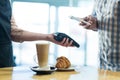 Man paying bill through smartphone using NFC technology Royalty Free Stock Photo