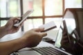 Man paying with credit card on smart phone at home office. Royalty Free Stock Photo