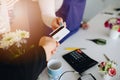 Man paying for flowers with his debit card.