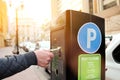 Man is paying his parking using credit card at parking pay station terminal. Royalty Free Stock Photo