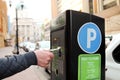 Man is paying his parking using credit card at parking pay station terminal. Royalty Free Stock Photo