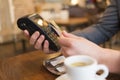 Man paying with NFC technology , credit card, in restaurant, bar Royalty Free Stock Photo