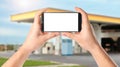 Man paying for refueling via smartphone at gas station, closeup. Device with empty screen Royalty Free Stock Photo