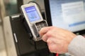 Man paying at the self-service counter entering credit card pin code for security password in credit card swipe machine. shopping. Royalty Free Stock Photo