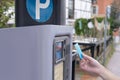 man pays with bank card for time of parking car in street parking meter, rhythm of city life, Technology in Urban Environment in Royalty Free Stock Photo