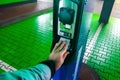 A man pays for charging an electric car. Hand holding catd to pay at charging station. Concept of green electricity, clean