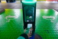 A man pays for charging an electric car. Hand holding catd to pay at charging station. Concept of green electricity, clean Royalty Free Stock Photo