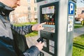 Man pays for parking with a credit card with NFS technology. Easy payment. Process of paying in machine parking terminal. Payment Royalty Free Stock Photo