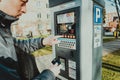 Man pays for parking with a credit card with NFS technology. Easy payment. Process of paying in machine parking terminal. Payment Royalty Free Stock Photo