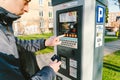 Man pays for parking with a credit card with NFS technology. Easy payment. Process of paying in machine parking terminal. Payment Royalty Free Stock Photo