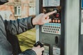 Man pays for parking with a credit card with NFS technology. Easy payment. Process of paying in machine parking terminal. Payment Royalty Free Stock Photo