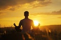 Man Peacefully Meditating In A Serene Yoga Pose During Golden Sunset