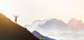 Man on peak of mountain. Emotional scene. Young man with backpack standing with raised hands on top of a mountain and enjoying mo Royalty Free Stock Photo