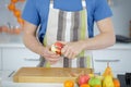 man pealing apple with knife