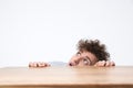 Man peeking from behind the desk Royalty Free Stock Photo