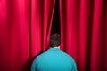 Man Peeking Through A Stage Curtain Royalty Free Stock Photo