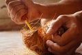 man peeling coconut