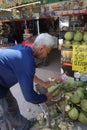 A man peeling coconut, Thailand