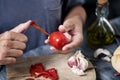 Man peeling a scalded tomato