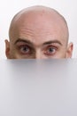 Man peering over a cubicle Royalty Free Stock Photo