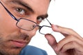 Man peering over his glasses