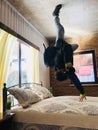 Man performing breakdance move inside modern bedroom Royalty Free Stock Photo