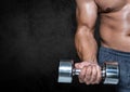 Man performing dumbbell curl exercise against black background Royalty Free Stock Photo