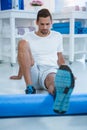 Man performing exercise using foam roll