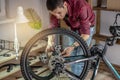 Man is performing maintenance on his mountain bike. Concept of fixing and preparing the bicycle for the new season