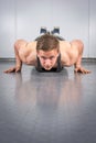 Man performing push ups at the gym