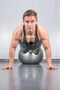 Man performing push ups at the gym