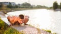 Man performing push ups by the river