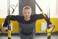 Man performing TRX suspension training in gym Royalty Free Stock Photo