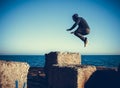 Man performs freerunning jump on stones Royalty Free Stock Photo